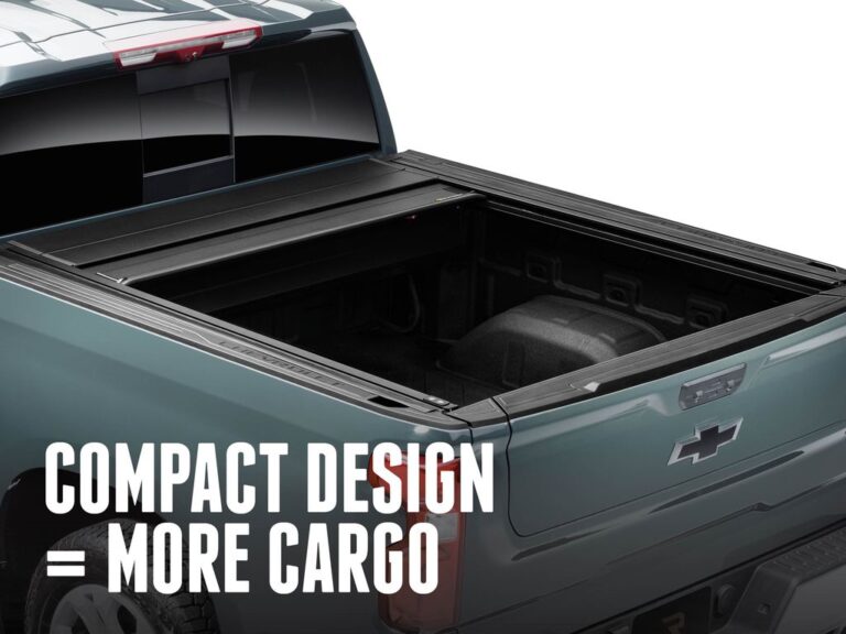 RealTruck FlushFit TS cover partially open on a green Chevrolet Silverado showing the compact tight-roll canister, COMPACT DESIGN MORE CARGO text overlay