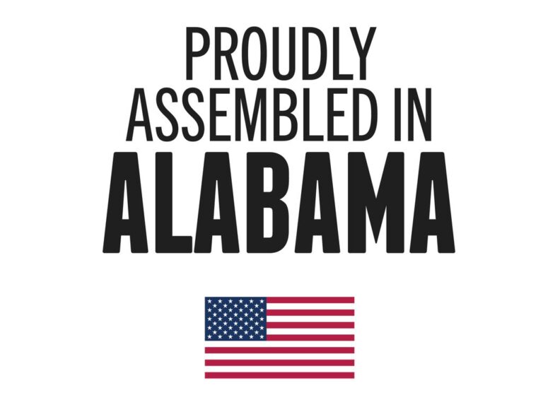 RealTruck proudly assembled in Alabama badge with American flag on textured background, Made in USA certification graphic