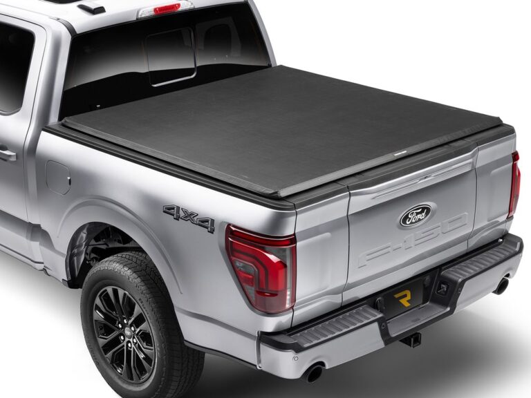 RealTruck TruXedo TruXport GEN 2 soft roll-up tonneau cover fully closed on a silver 2024 Ford F-150 STX 4x4, rear three-quarter view showing the smooth low-profile fit on white background