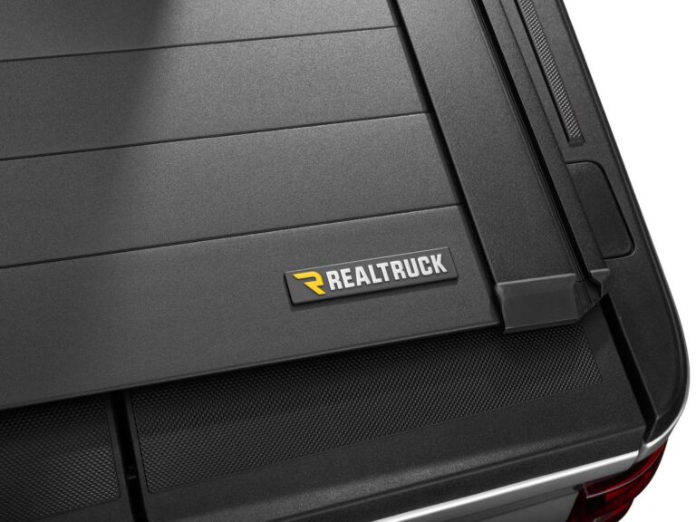 RetraxPRO EZ-OFF cover partially open on a silver Ford F-150, holding the cover in mid-position, INFINITELY FLEXIBLE unlimited positions text overlay