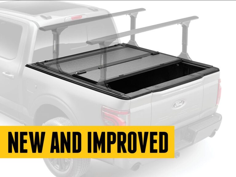 BAKFlip MX4 TS hero marketing image with rear panel flipped open and crossbars mounted, ghosted silver Ford F-150 silhouette with NEW AND IMPROVED yellow banner overlay