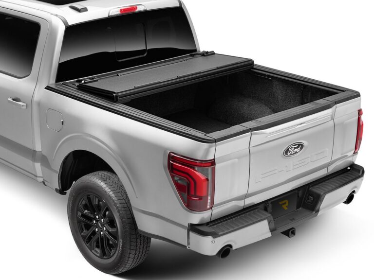 BAKFlip MX4 cover on a silver Ford F-150 with the rear panel folded forward toward the cab, partially open position, rear three-quarter angle on white background