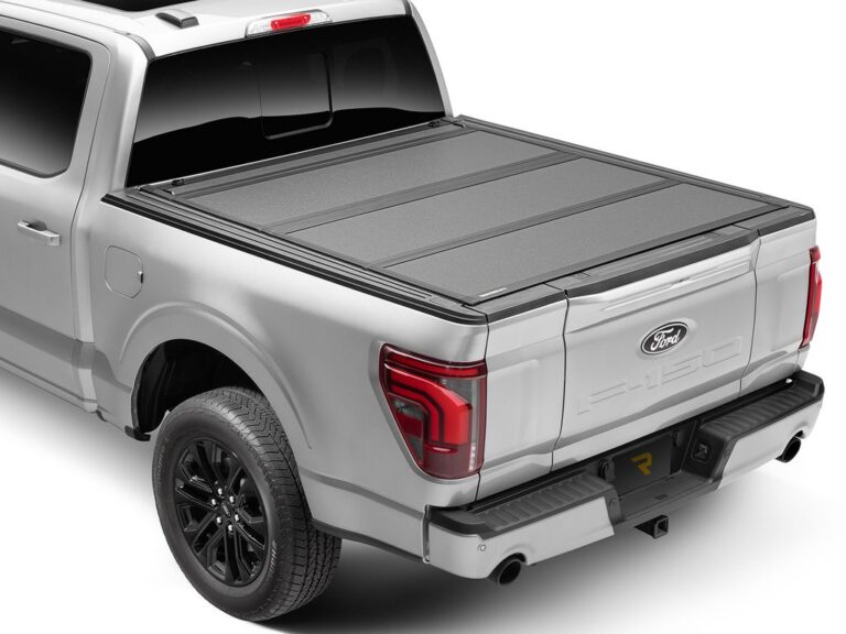 BAKFlip MX4 cover fully closed on a silver Ford F-150, sitting flush with the bed rails, rear three-quarter angle on white background