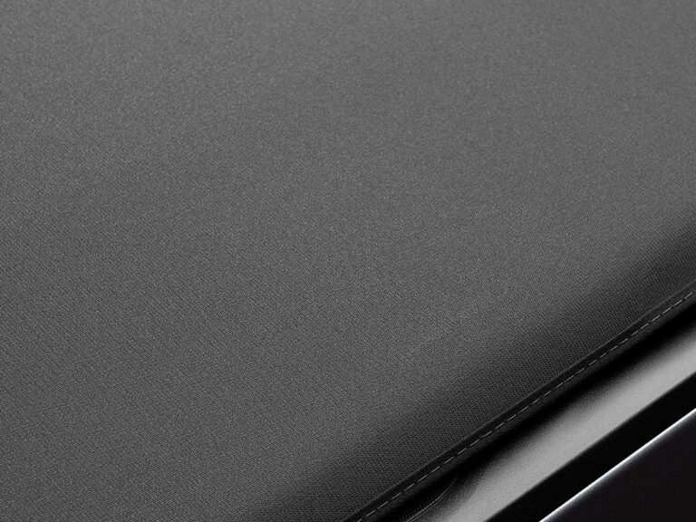 Extang Trifecta Signature 2.0 heavy-duty leather-grain canvas top material texture close-up, showing the premium matte black weave