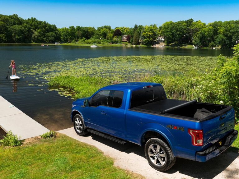 Lifestyle shot of a white Ford F-150 with the Lo Pro cover closed in a residential driveway