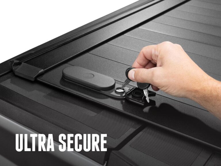 RetraxPRO EZ-OFF cover fully closed on a silver Ford F-150, top-down angle showing the key-lockable TraxLatch handle, ULTRA SECURE text overlay