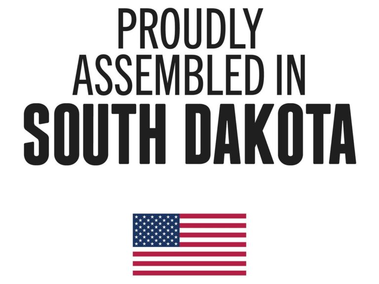 RealTruck x TruXedo proudly assembled in South Dakota badge with American flag, on a black textured background
