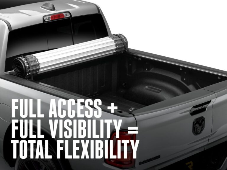 RealTruck BAK Revolver X2 cover fully rolled up and secured against the cab of a silver Ram 2500 Longhorn demonstrating 100 percent bed access, FULL ACCESS PLUS FULL VISIBILITY text