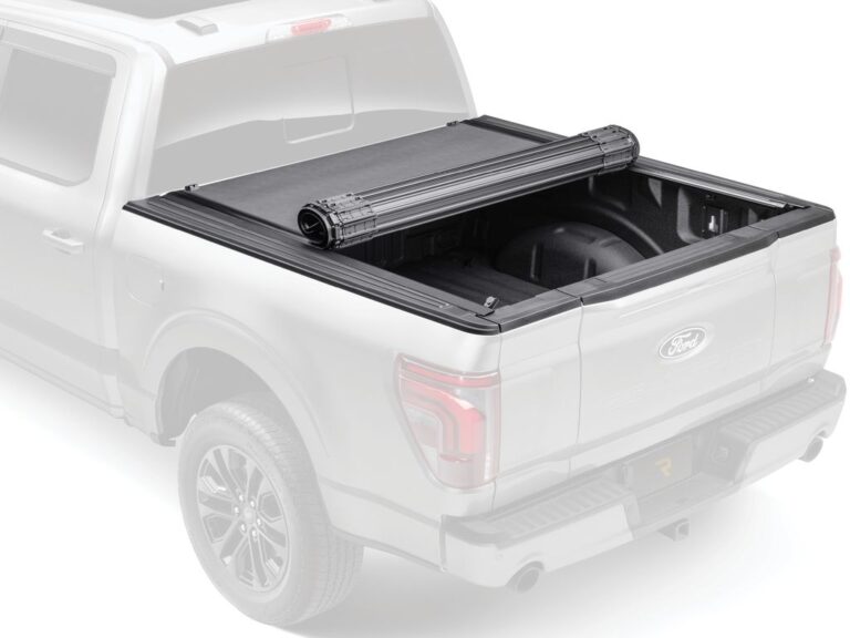 BAK Revolver X4S hero marketing image on a silver Ford F-150 with ghosted dimmed background, cover partially open at the bulkhead