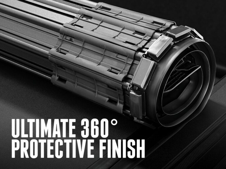 Close-up of the BAK Revolver X4S rolled cover bundle with end caps visible demonstrating the matte black 360-degree protective finish, with text overlay reading ultimate 360 degree protective finish