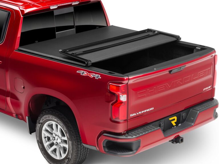 Red Chevy Silverado 4x4 with Extang Trifecta 2.0 soft folding tonneau cover fully closed and tailgate up, rear three-quarter angle on white background