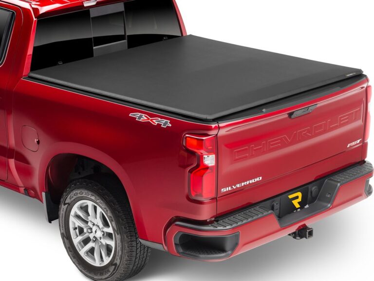 Red Chevy Silverado 4x4 with Trifecta 2.0 cover fully closed and flush, tailgate up, rear three-quarter angle on white background