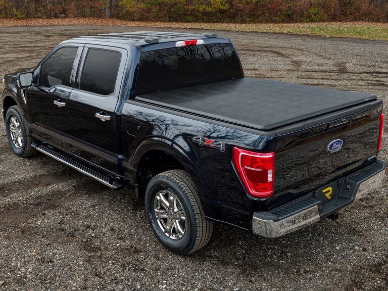 Black Ford F-150 4x4 with Trifecta 2.0 cover fully closed, low-profile look, autumn outdoor setting